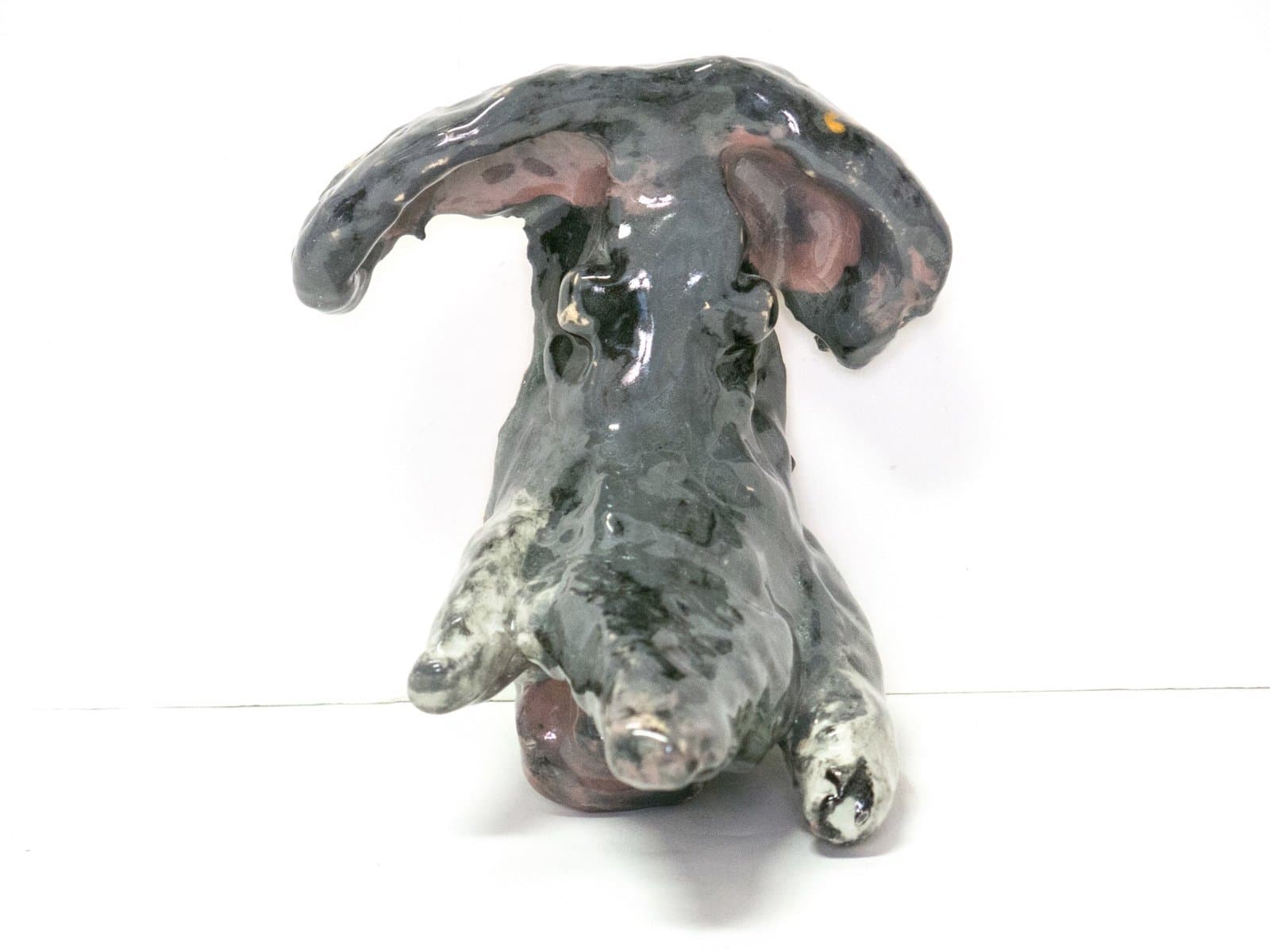 Ceramic sculpture of abstract organic form with grey-green glaze and pink accents, resembling mushroom or biomorphic shape
