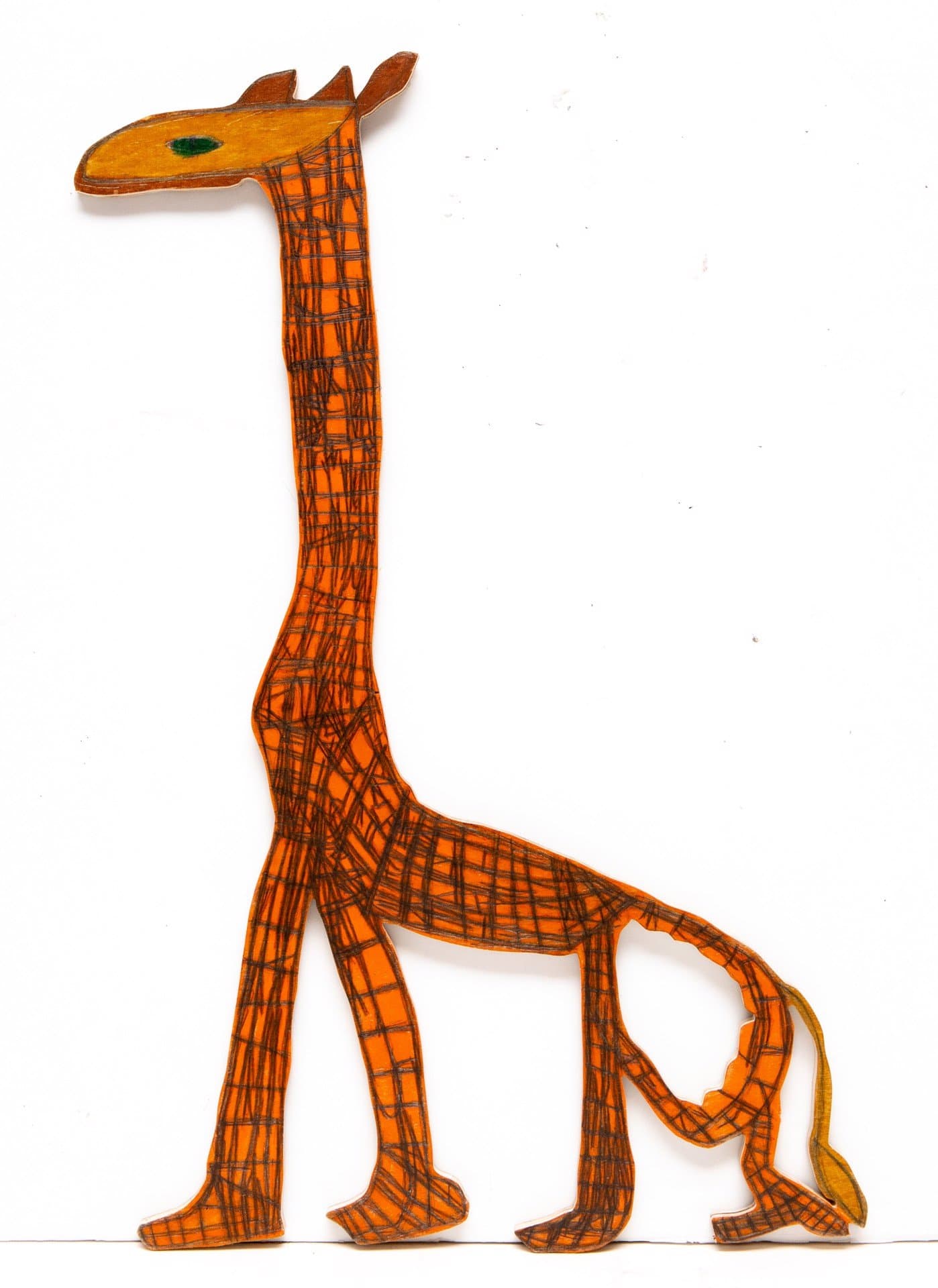Cut-out wooden giraffe figure with orange base color and black crosshatch pattern, green eye detail on white background.