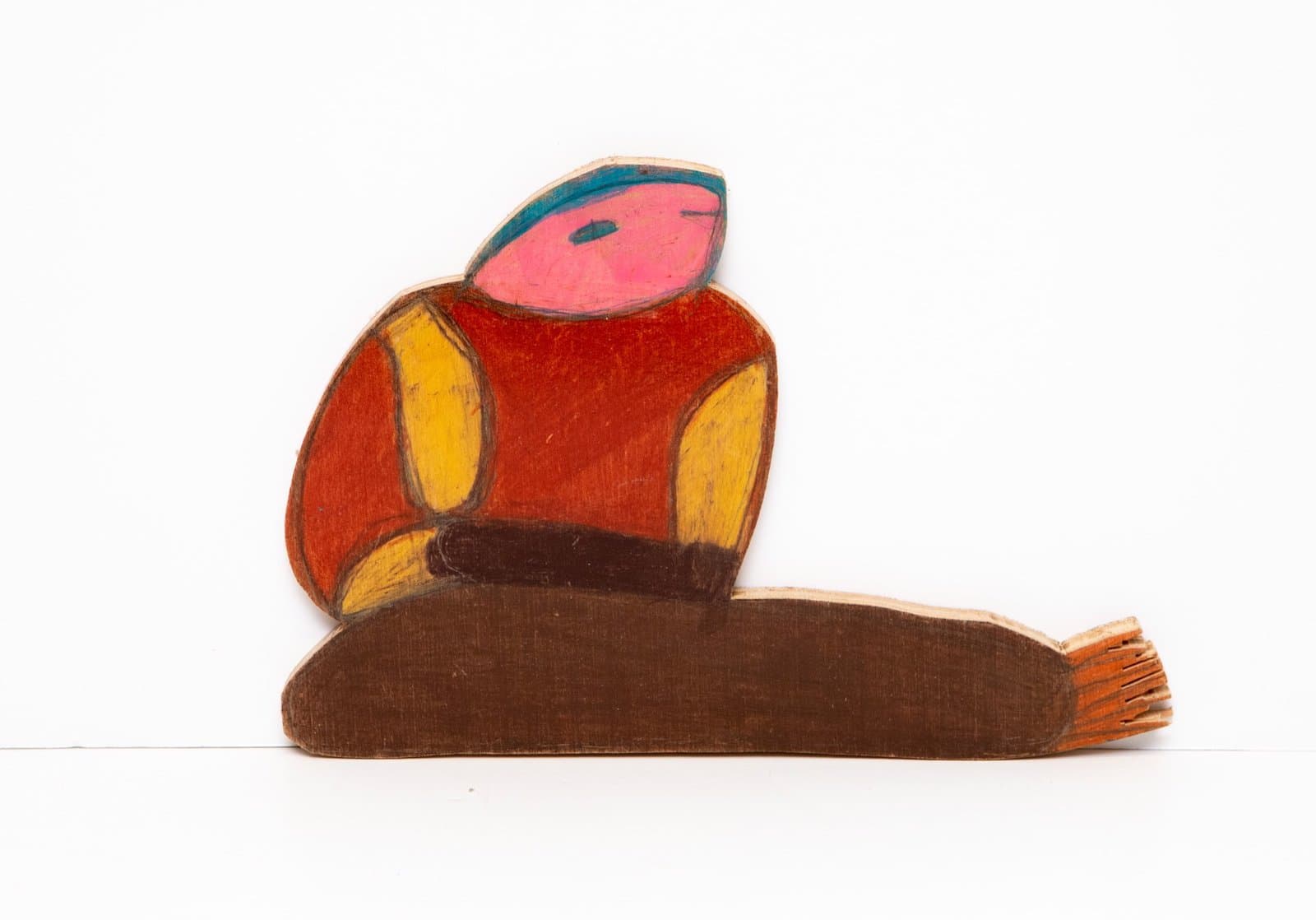 Colorful painted wooden sculpture of a stylized figure with pink head, red torso, and brown base on white background.