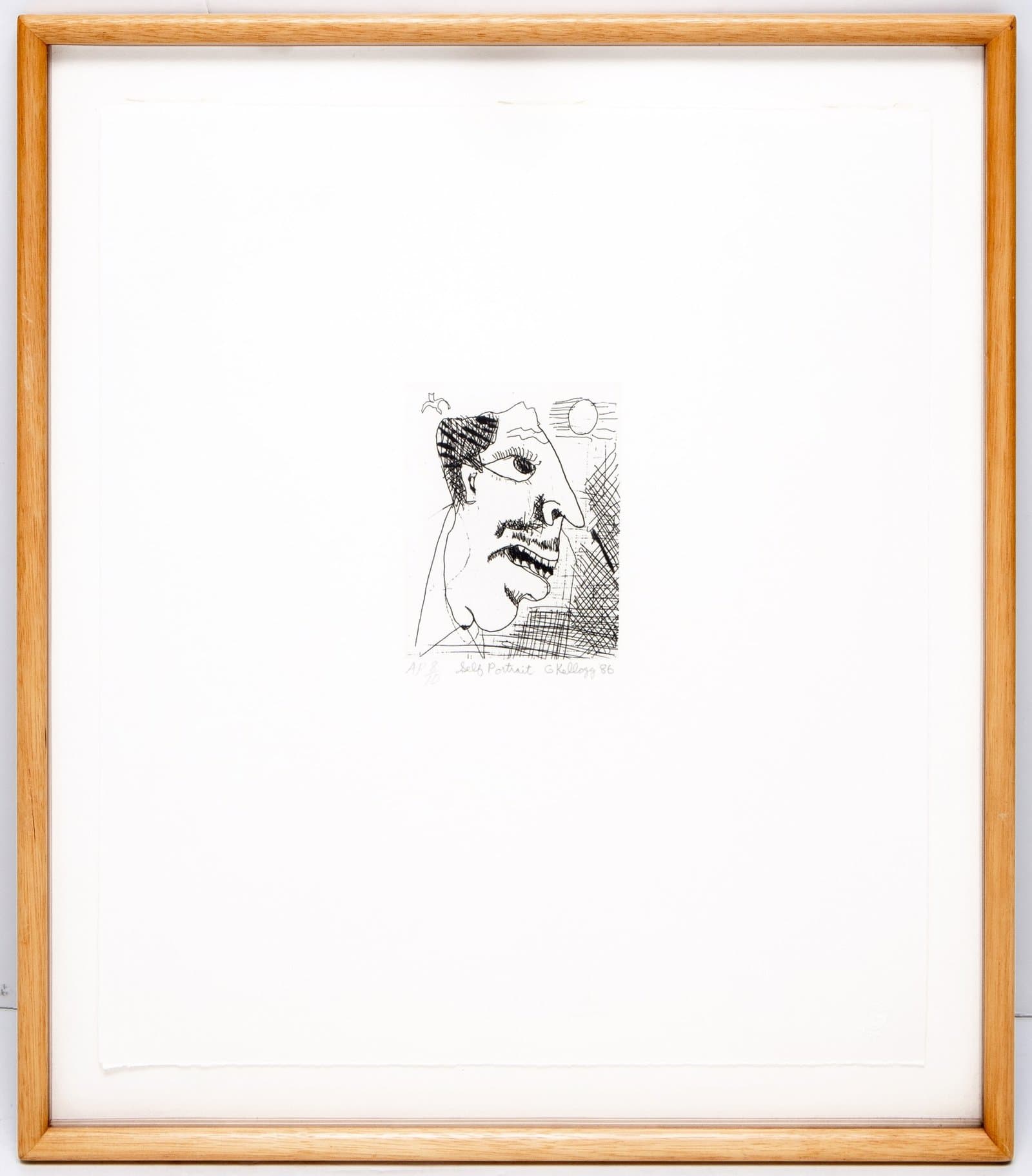 Black and white etching of a distorted human face with exaggerated features, framed in light wood