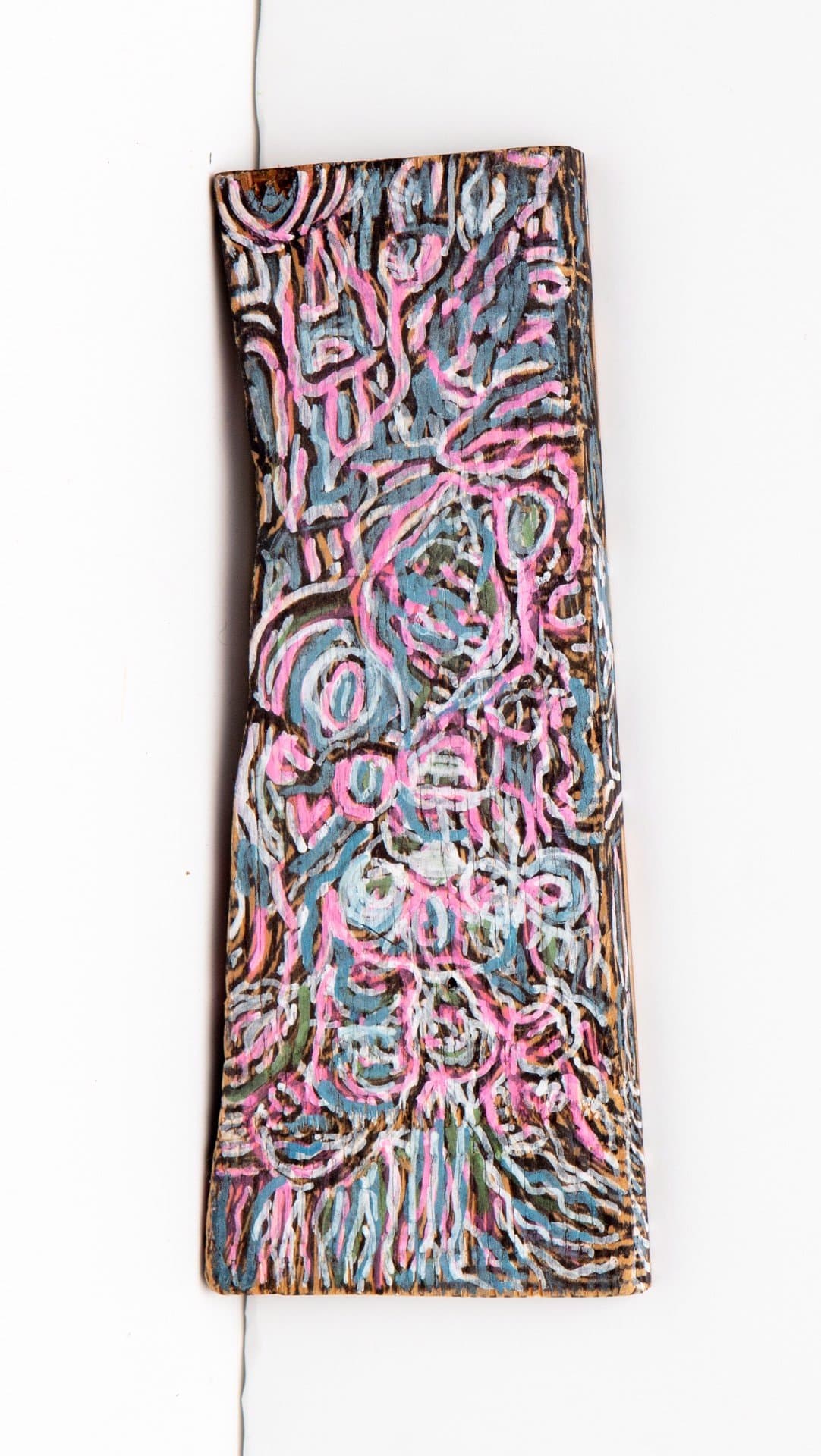 Abstract painting on wood with swirling patterns in pink, blue, and brown acrylic paint on a rectangular panel.