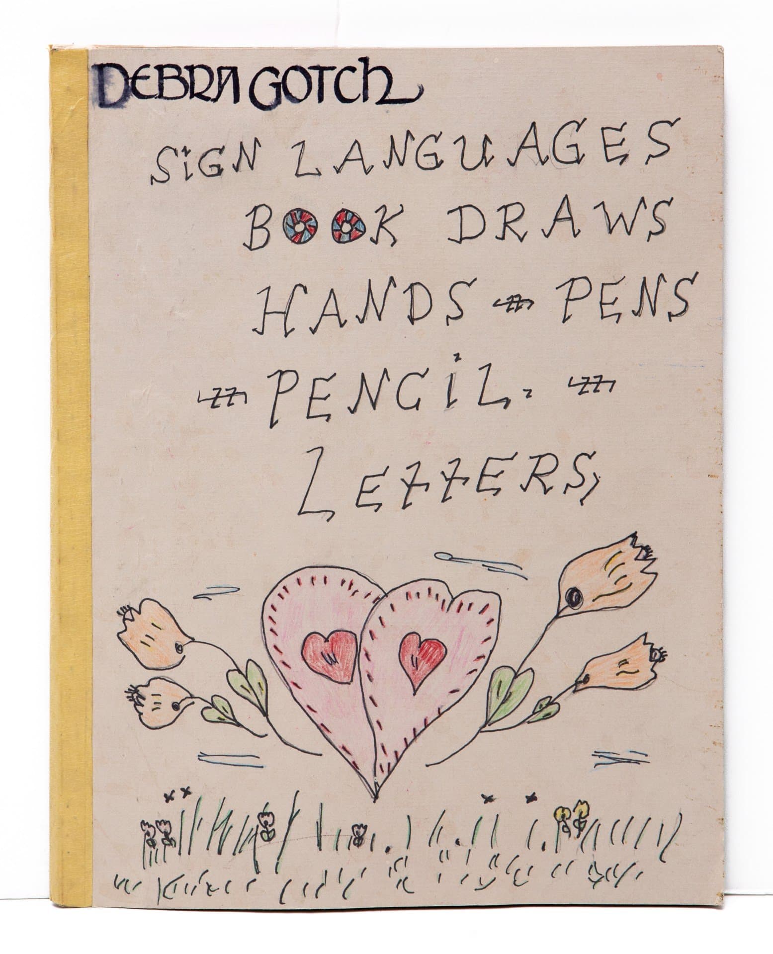 Handmade book cover with text and drawing in ink and colored pencil featuring a heart with wings and birds on cream paper