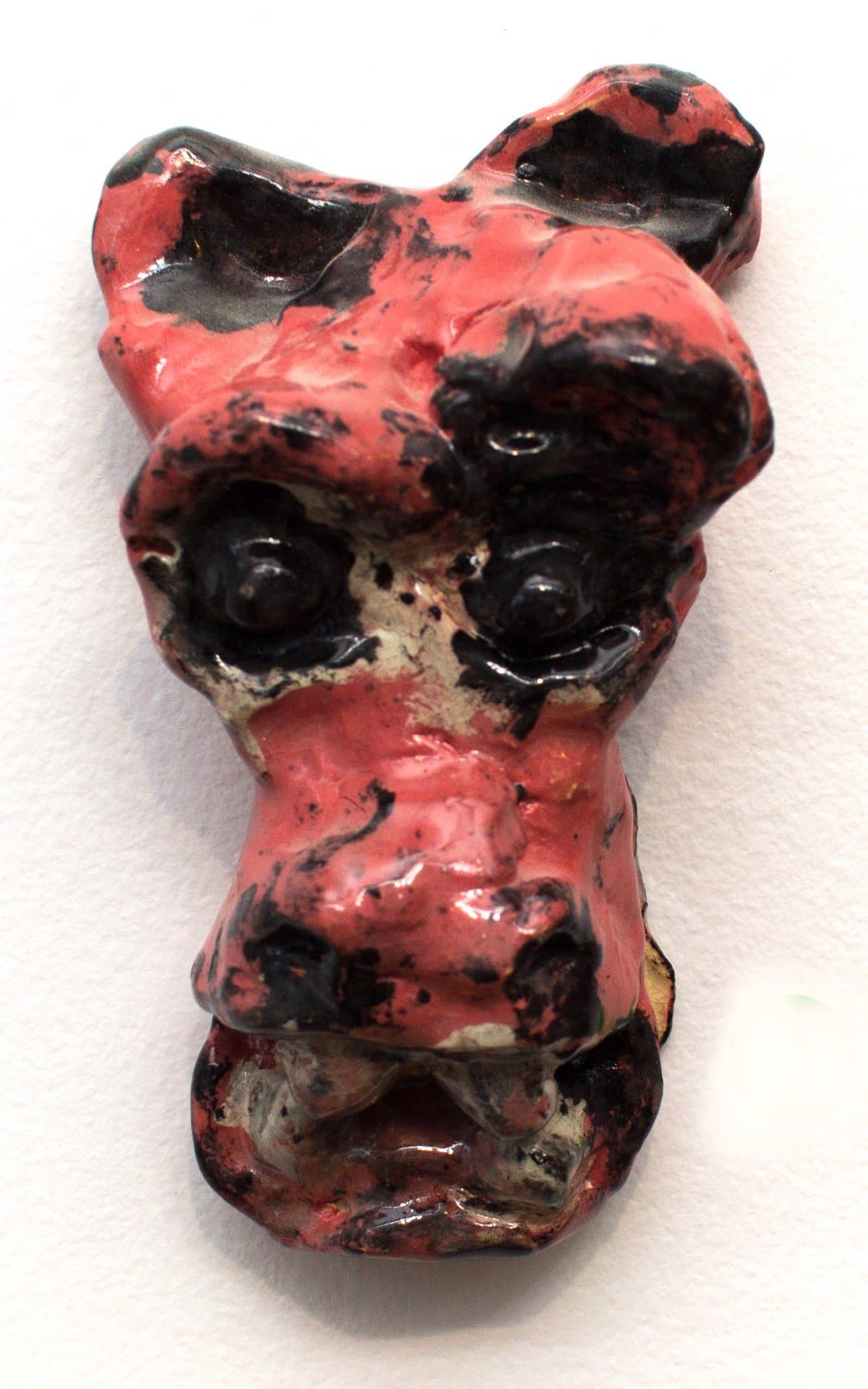 Ceramic sculpture with glossy red and black glaze, abstract organic form with hollow cavities